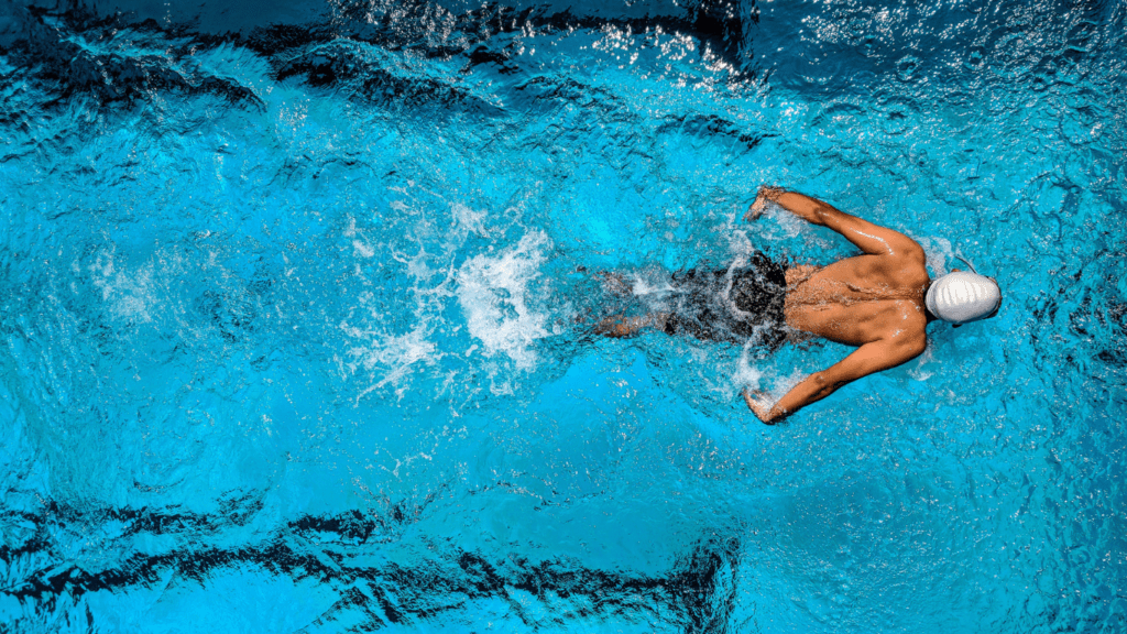 a man swimming in an olympic pool