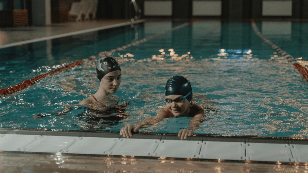 two person practicing swimming together