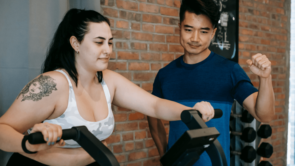 a man motivating a woman in exercising