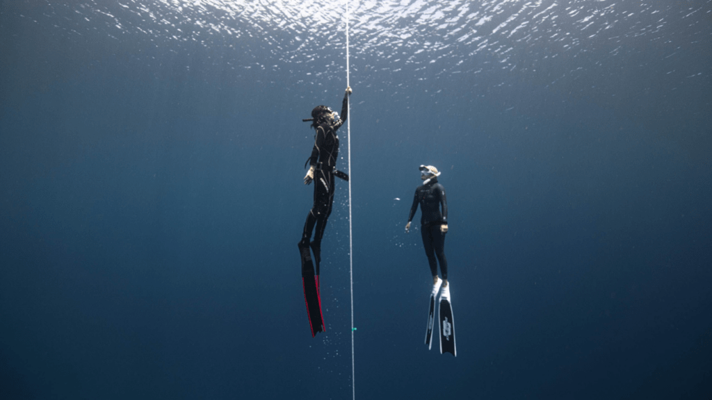 two divers wearing swim fins