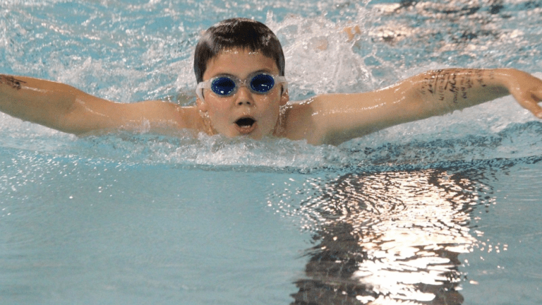 a kid in a swimming pool