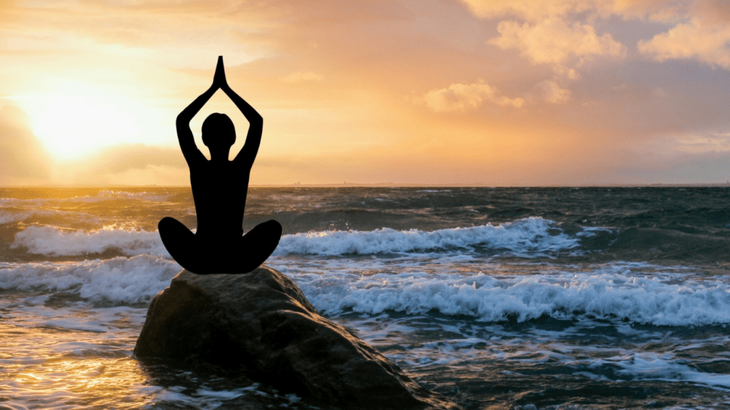 a person doing yoga at a seashore